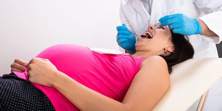 Pregnant woman getting a dental examination